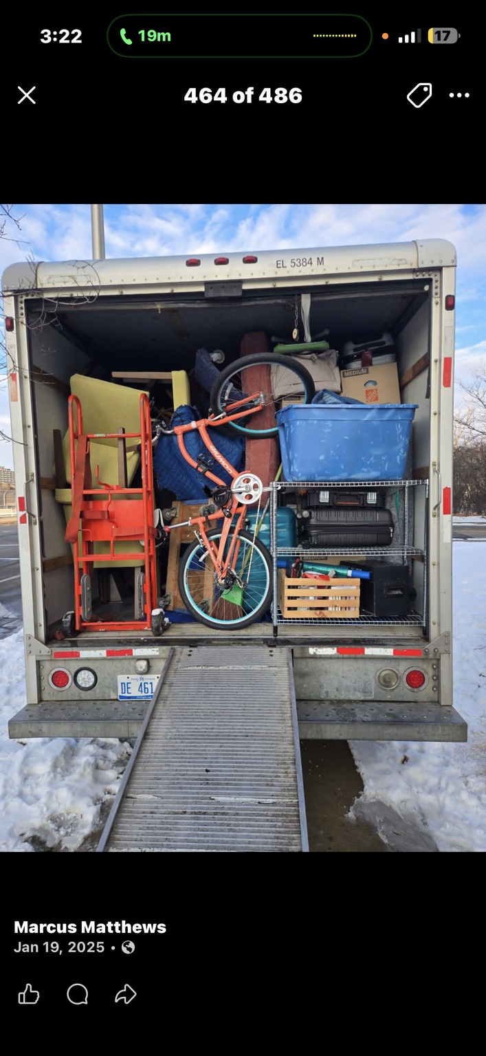 Furniture, a bicycle, and household belongings packed into a moving truck