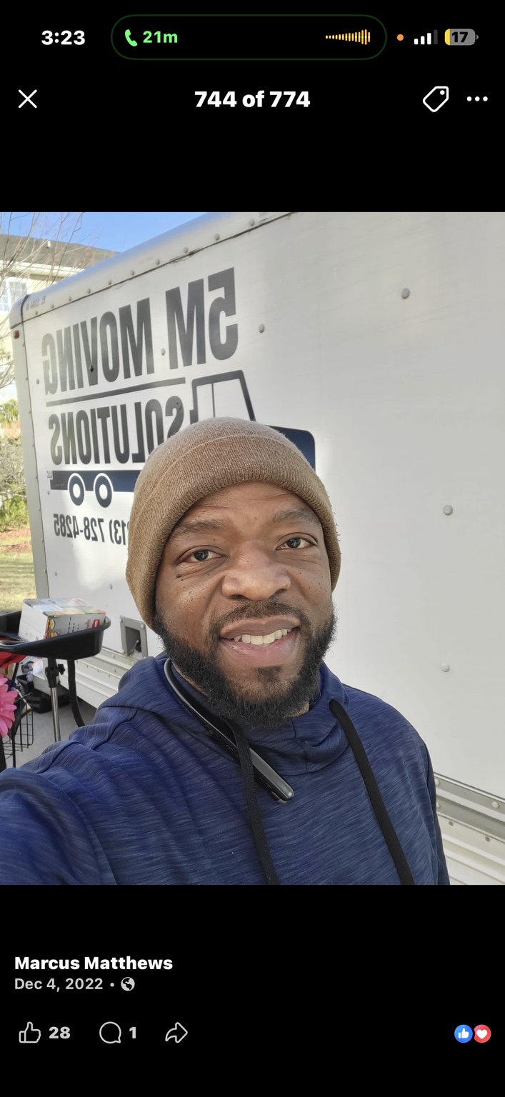 A man beside the 5M branded moving truck